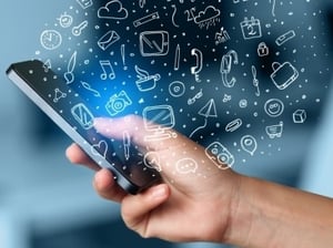 Hand holding smartphone with hand drawn media icons and symbols concept.jpeg Hand holding smartphone with hand drawn media icons and symbols concept.jpeg