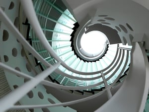 modern glass spiral staircase with metallic hand-rails.