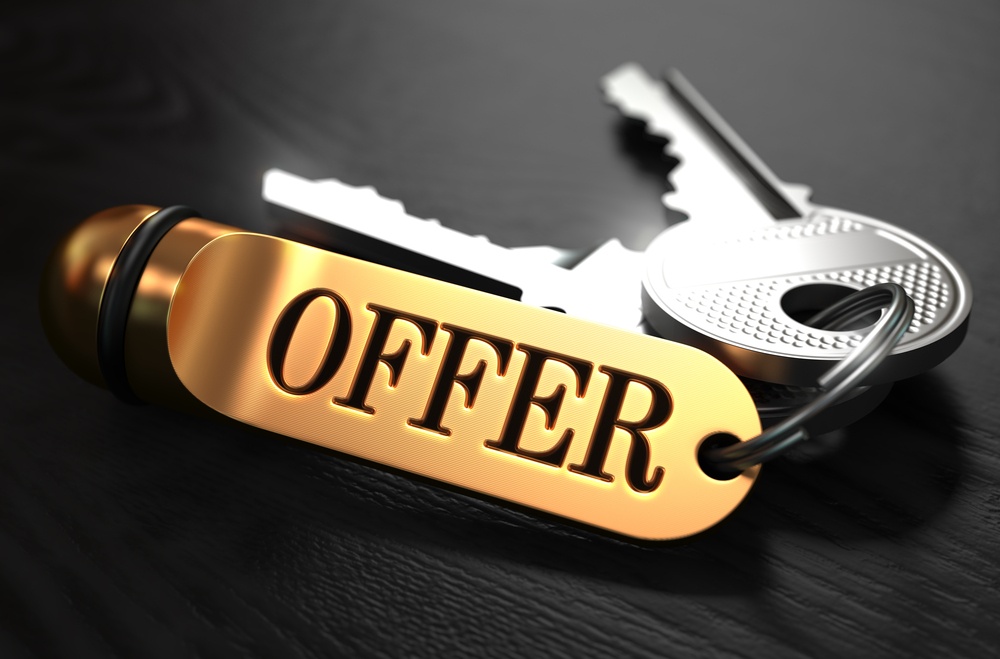 Keys with Word Offer on Golden Label over Black Wooden Background. Closeup View, Selective Focus, 3D Render..jpeg